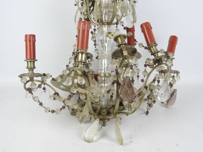 Metal eight-arm chandelier adorned with pendants....