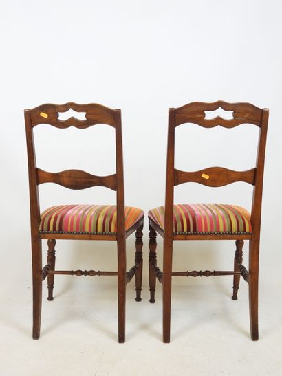 PAIR OF CHAIRS in carved wood, the seat covered...