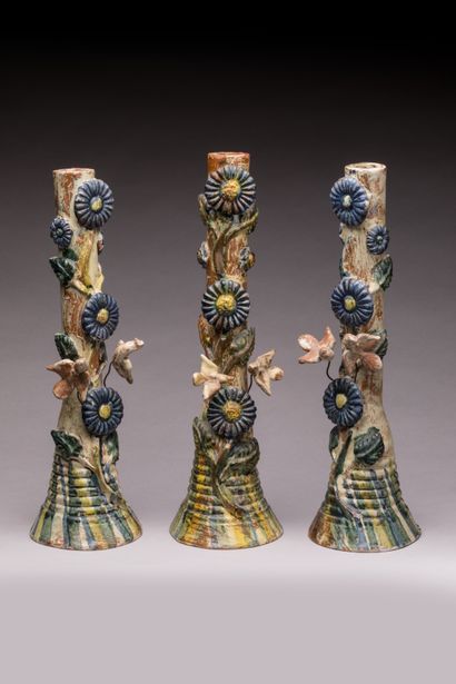 POPULAR ART: Three glazed terracotta candleholders...
