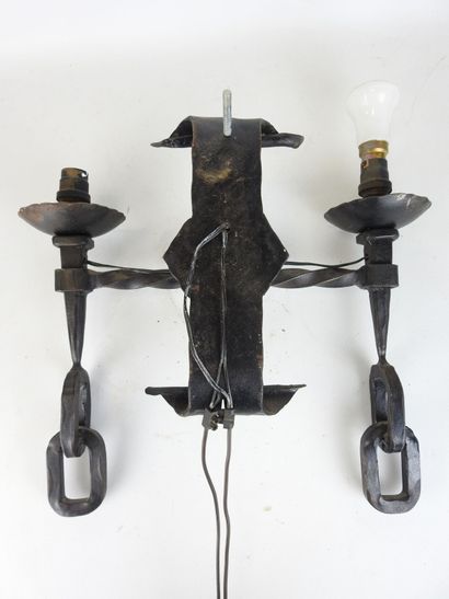 Wrought-iron sconce with two arms forming...