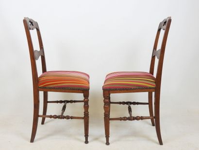 PAIR OF CHAIRS in carved wood, the seat covered...