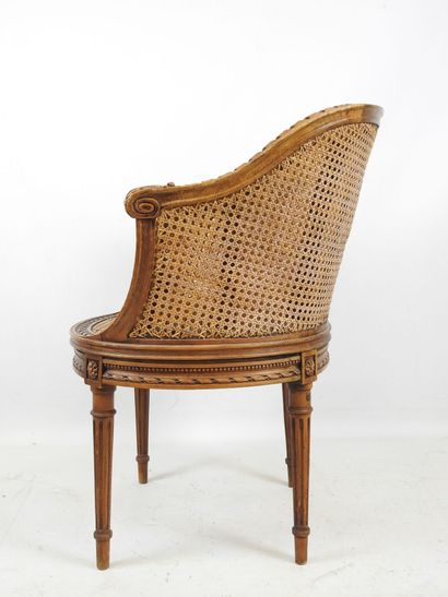 Walnut caned armchair, molded and carved...