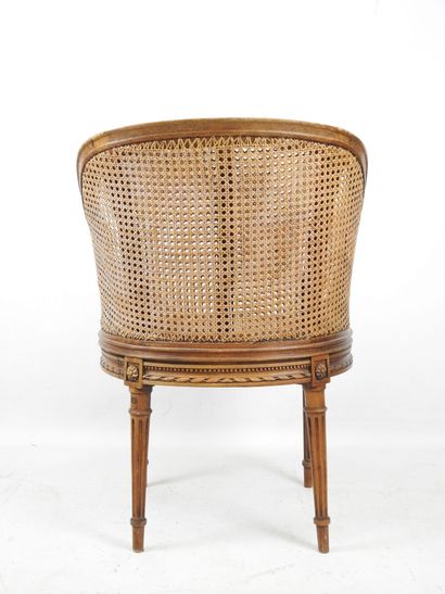 Walnut caned armchair, molded and carved...