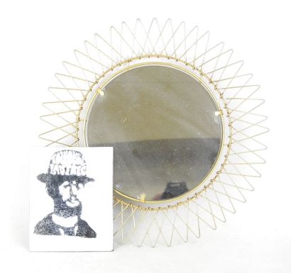 Circular gilded metal mirror in the shape...