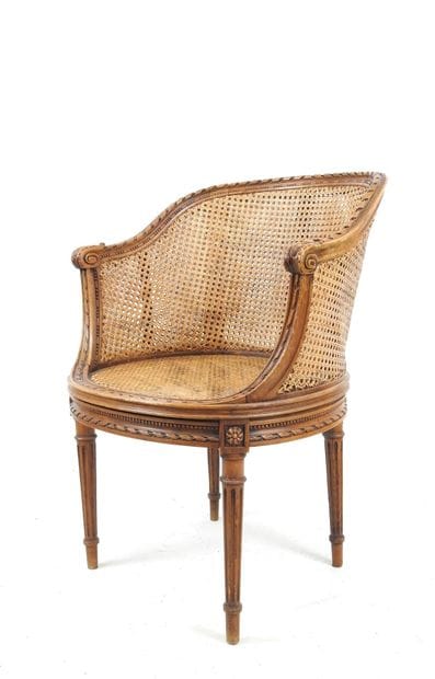 Walnut caned armchair, molded and carved...