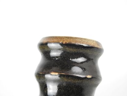 Black glazed ceramic ring-shaped CANDLESTICK....