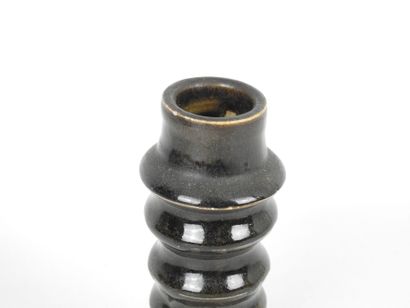 Black glazed ceramic ring-shaped CANDLESTICK....