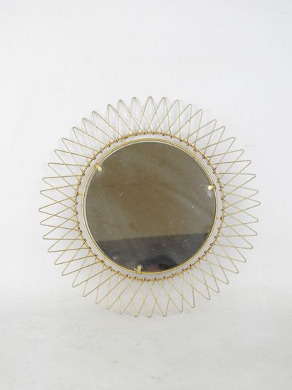 Circular gilded metal mirror in the shape...