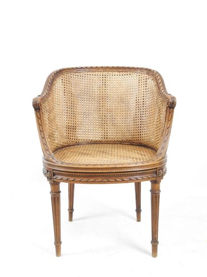 Walnut caned armchair, molded and carved...