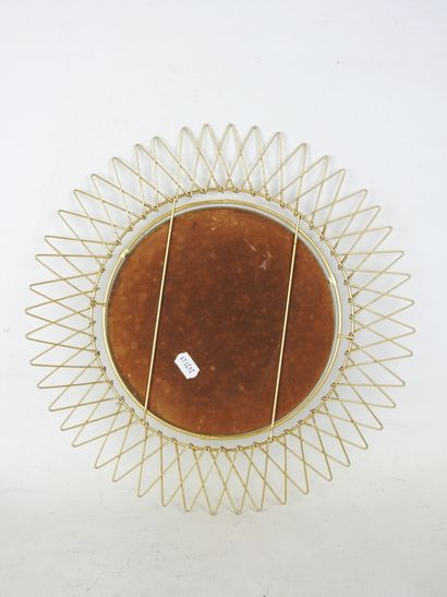 Circular gilded metal mirror in the shape...