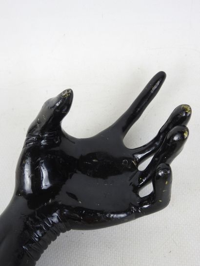 HAND wearing a fine black lacquered metal...