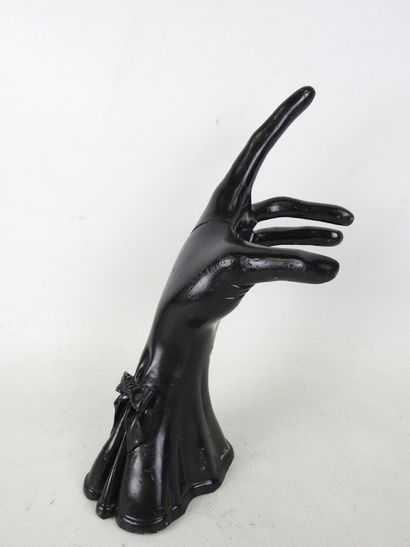 HAND wearing a fine black lacquered metal...