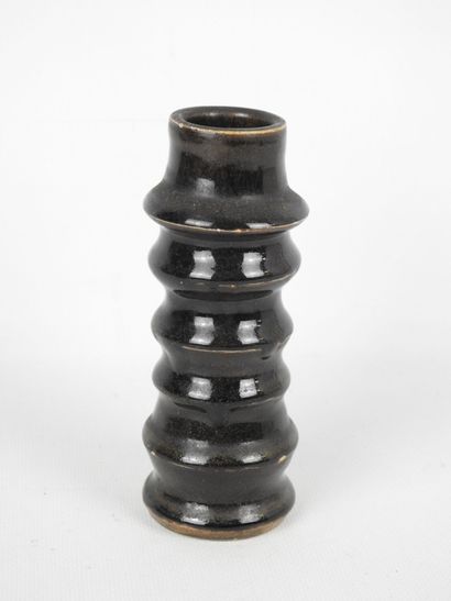 Black glazed ceramic ring-shaped CANDLESTICK....