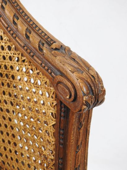 Walnut caned armchair, molded and carved...