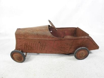 EUREKA: Pedal car in red painted sheet metal....