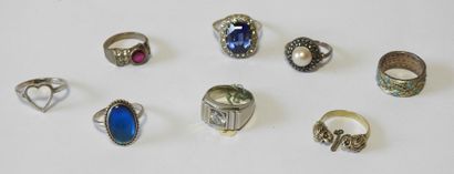 Eight rings set in silver, adorned with blue,...