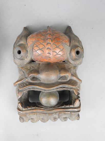 TIBET: Two carved wooden grimacing masks....