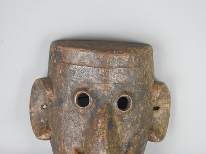 NEPAL: Carved wooden mask with brown patina...