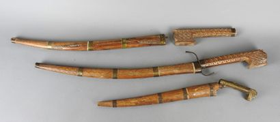 ALGERIA 
Three wooden short swords and scabbards...