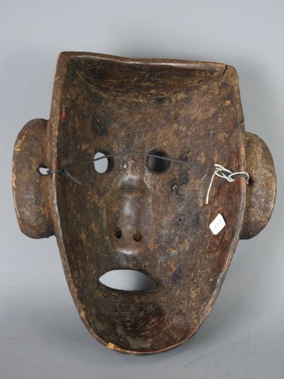NEPAL: Carved wooden mask with brown patina...