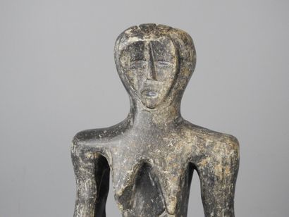 MALI: Carved stone statue of a female figure...