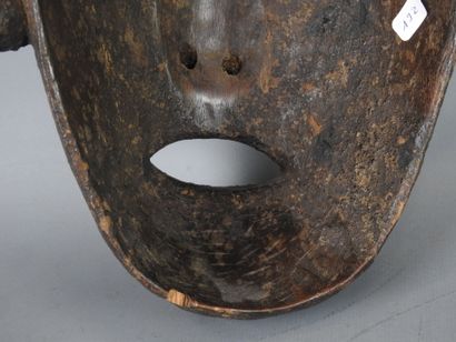 NEPAL: Carved wooden mask with brown patina...