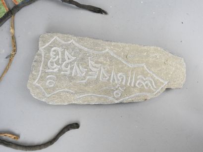 Stone amulet with carved inscription decoration....
