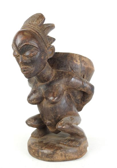 LUBA - CONGO : Squatting figure carrying...