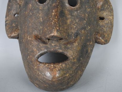 NEPAL: Carved wooden mask with brown patina...