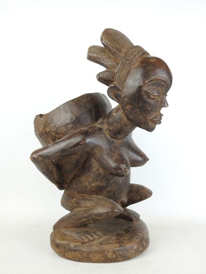 LUBA - CONGO : Squatting figure carrying...