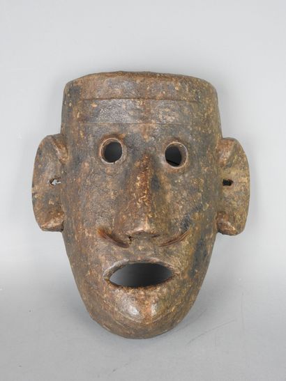 NEPAL: Carved wooden mask with brown patina...