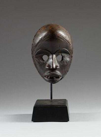 DAN, Ivory Coast. Carved and scarified hardwood,...