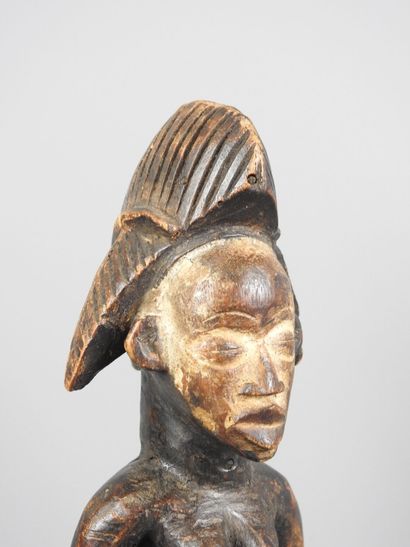 Female statuette, standing with hands on...