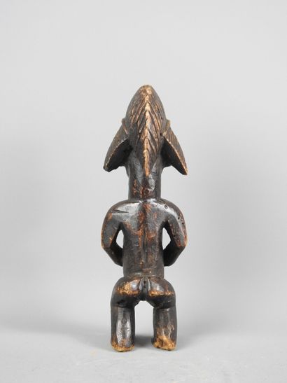Female statuette, standing with hands on...