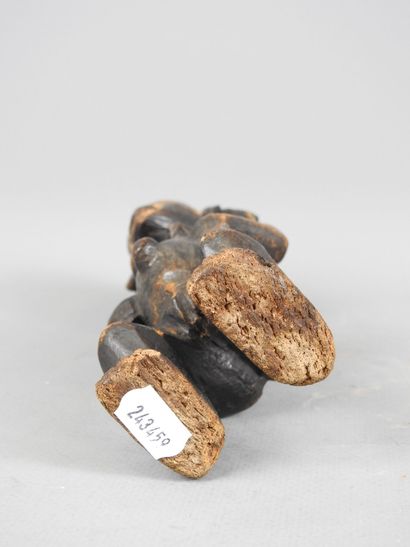 Female statuette, standing with hands on...