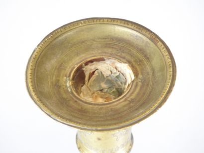 ORIENT: Gilt bronze candlestick with incised...