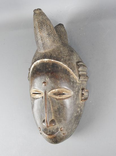 Baule Ivory Coast. Dance mask featuring a...