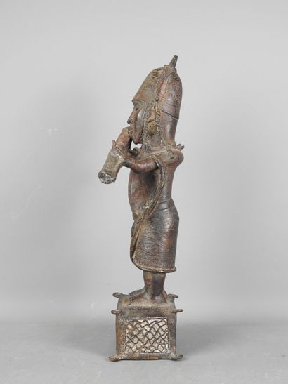 BENIN: Statue of a messenger blowing into...