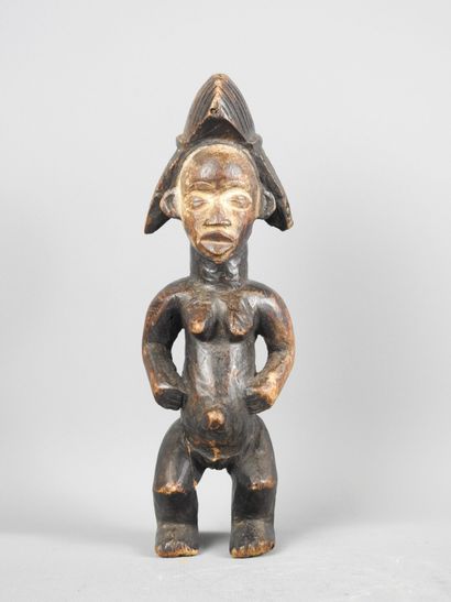 Female statuette, standing with hands on...
