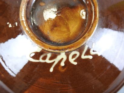 CAPELL : Deux grands plats en faïence. Signé...