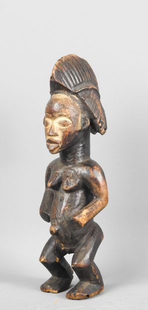 Female statuette, standing with hands on...