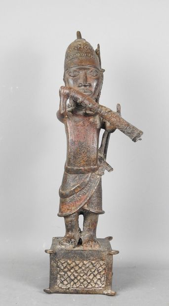 BENIN: Statue of a messenger blowing into...