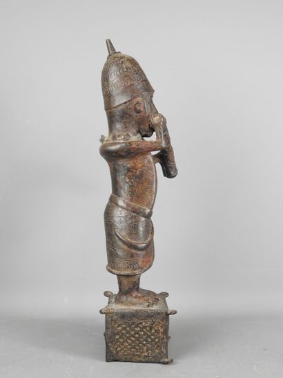 BENIN: Statue of a messenger blowing into...