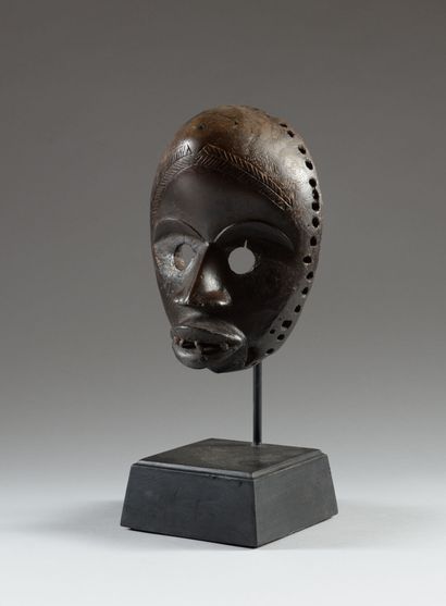 DAN, Ivory Coast. Carved and scarified hardwood,...