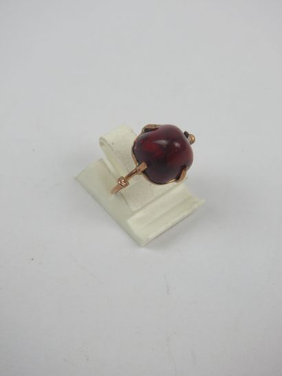 Gilded metal ring set with a red cabochon...