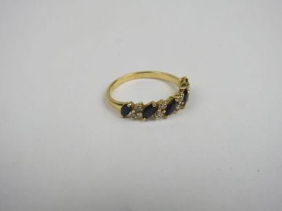 Half wedding band in 750 thousandths gold...