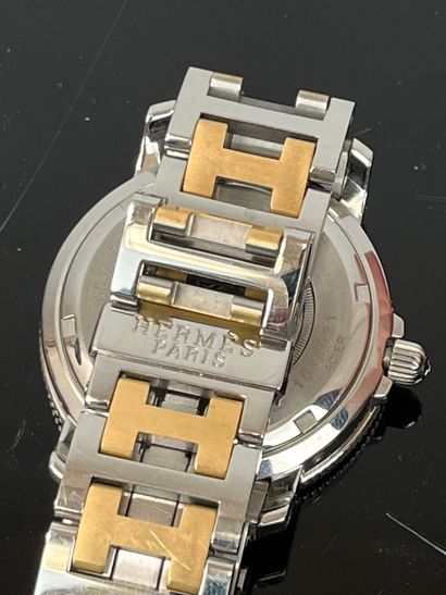 HERMES - Paris. Clipper steel and gold-plated...