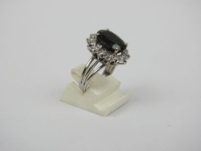 White gold ring set with a claw-set sapphire...