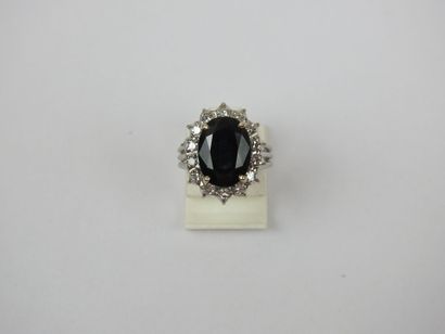 White gold ring set with a claw-set sapphire...