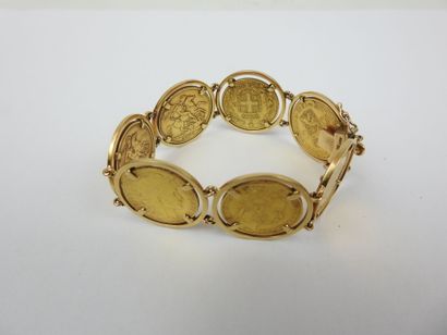 GOLD BRACELET adorned with 7 coins from various...